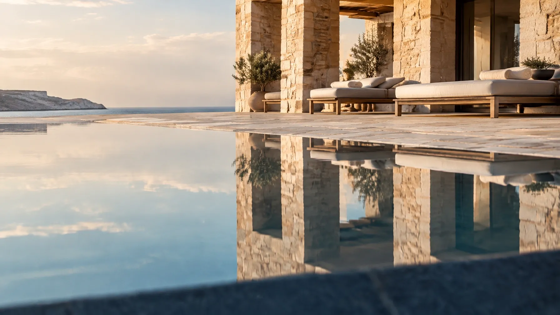Quiet hotel pool and architecture reflected at dawn